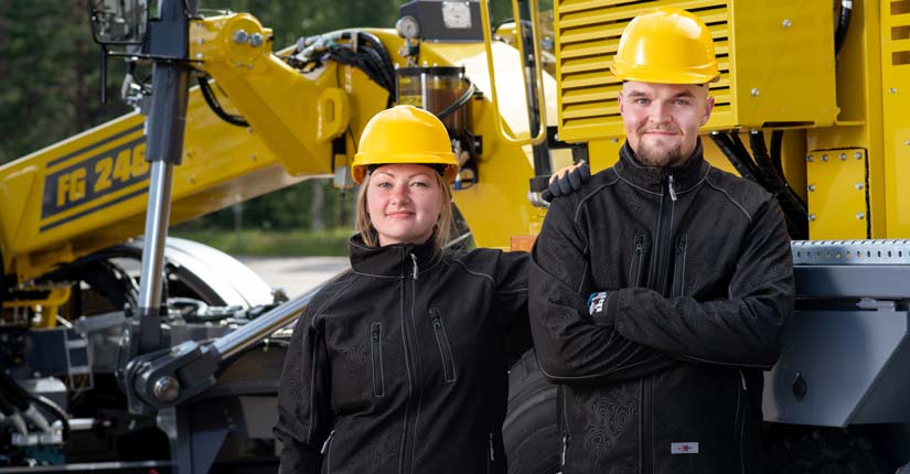 Priha työvaatteet, kuvassa mies ja nainen kypärä päässä