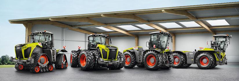 Neljä erilaista Claas-traktoria konehallissa.